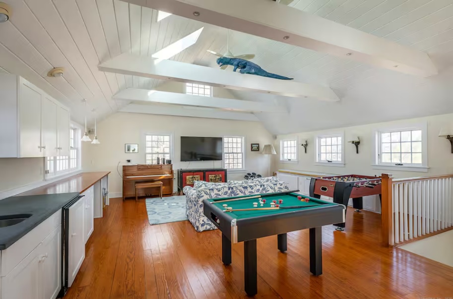 The loft game room with bumper pool, foosball, and a piano